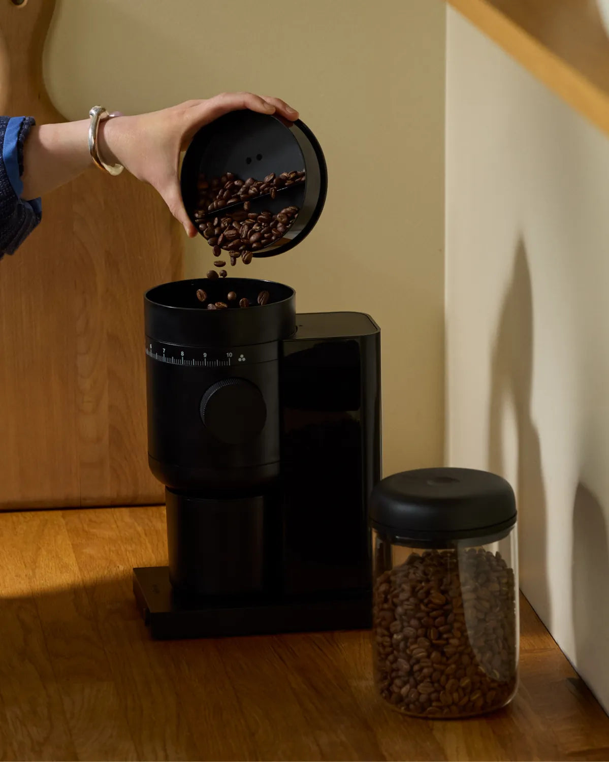 Whole beans poured into the Opus 2 grinder's load bin