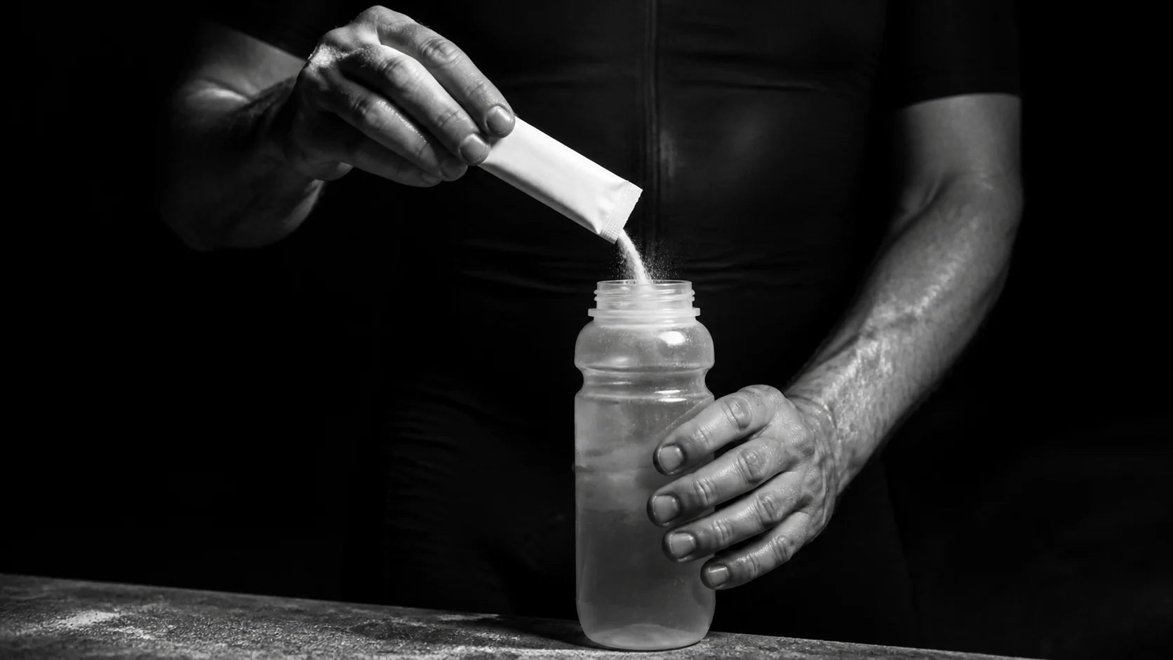 Endurance athlete adding a plain sachet to a measured bottle of water