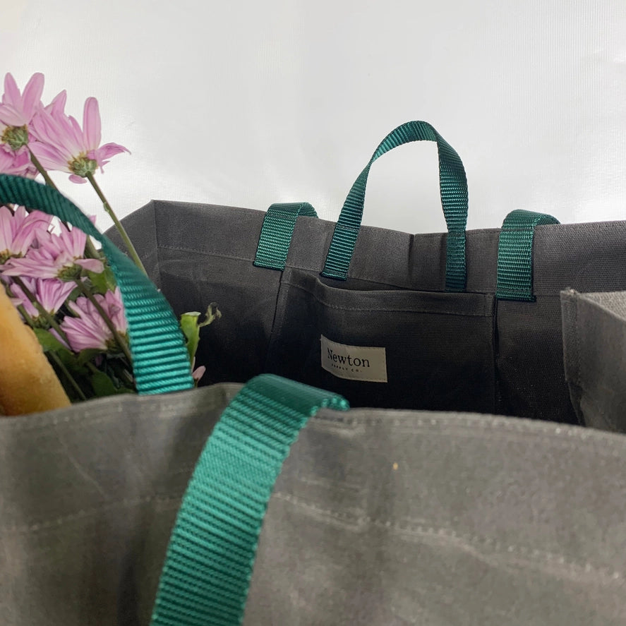 Slate waxed canvas tote with evergreen nylon straps and flowers