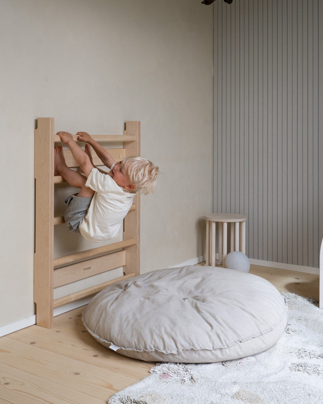 A child exploring HONKA wooden wall bars