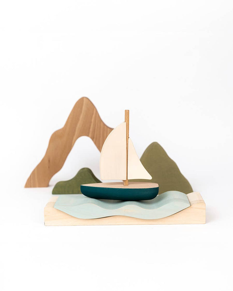 SABO Quiet Journey wooden sailboat on a wavy water platform with mountain shores