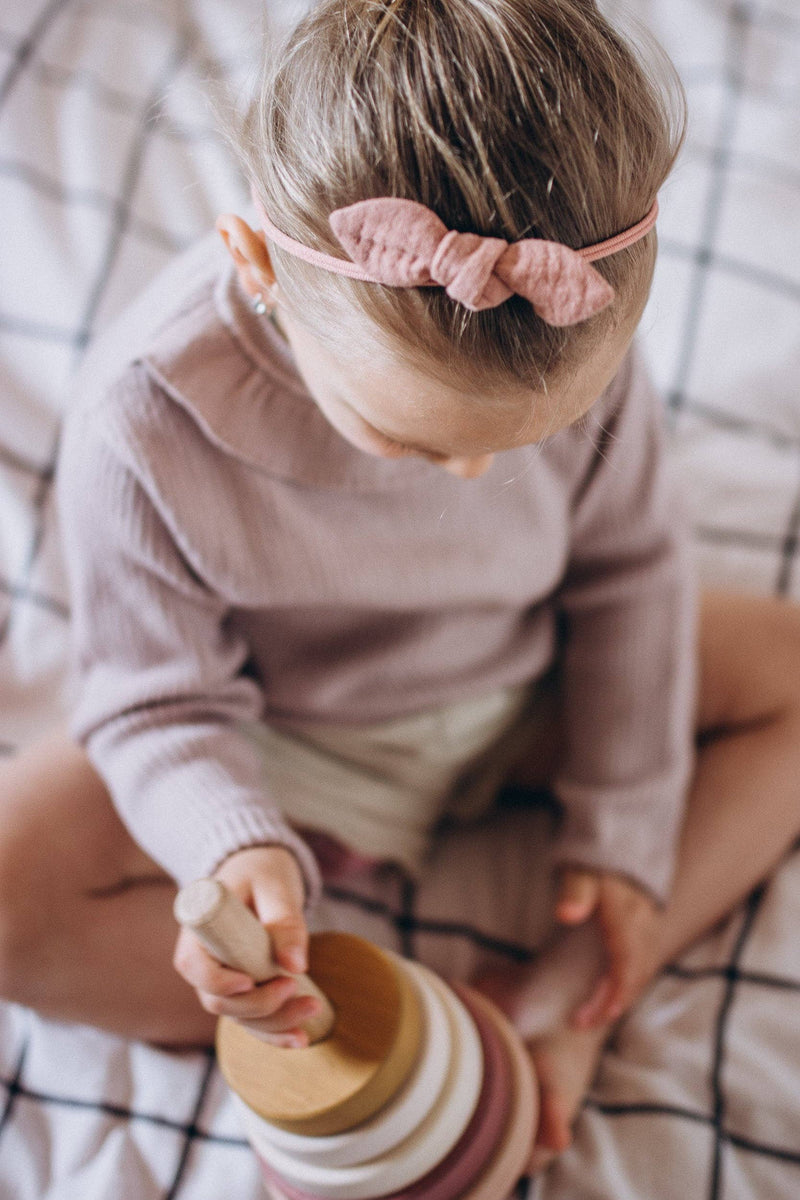 Child stacking the SABO wooden ring stacker