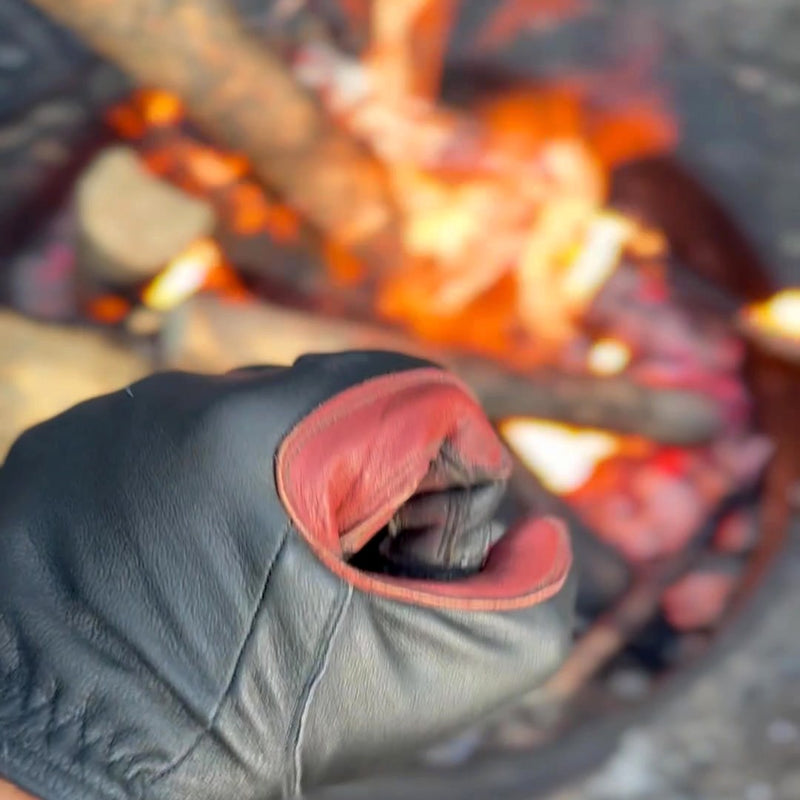 The D8 Fire Glove handling coals over an open fire