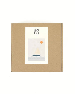 SABO Quiet Journey kraft box with sailboat illustration