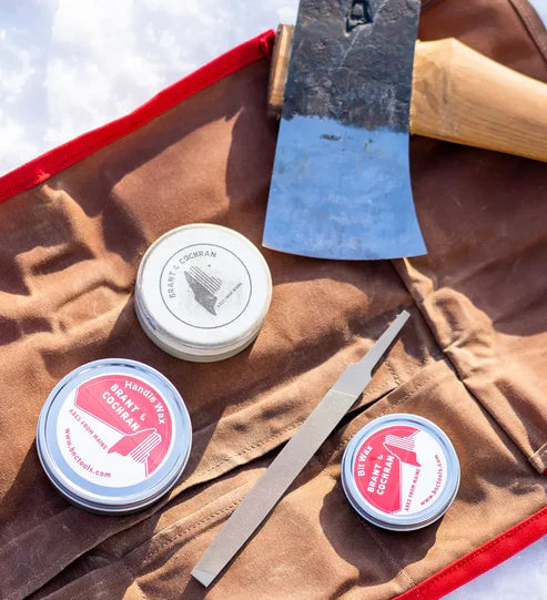Axe Care Kit tools arranged beside an axe head