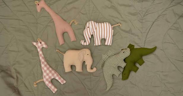 Senger Grabber animals including the beige plaid giraffe on a quilt