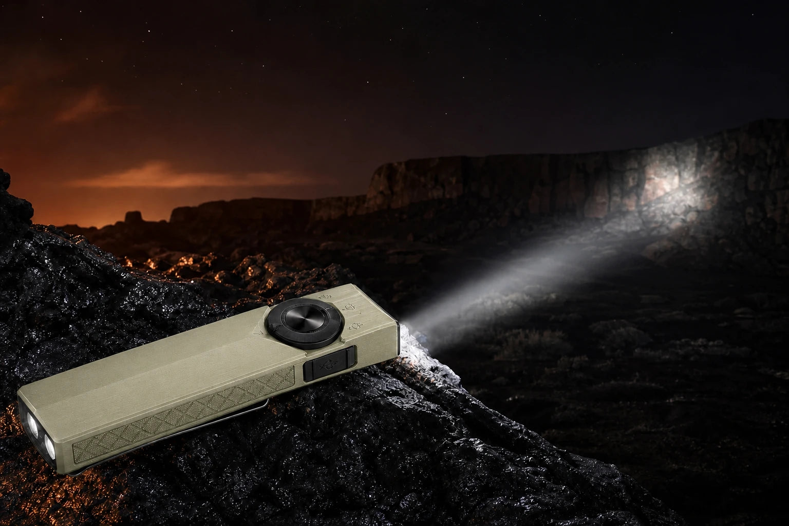 Olive Green ArkPro Ultra projecting a focused spotlight across volcanic terrain