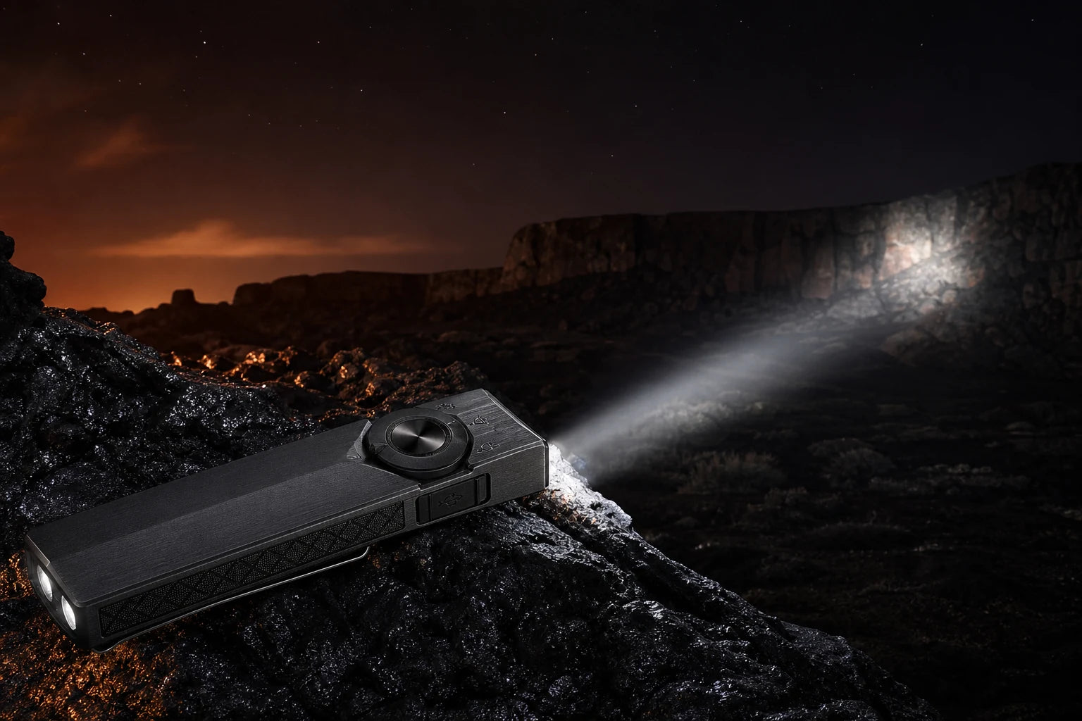 Onyx Black ArkPro Ultra projecting a focused spotlight across volcanic terrain