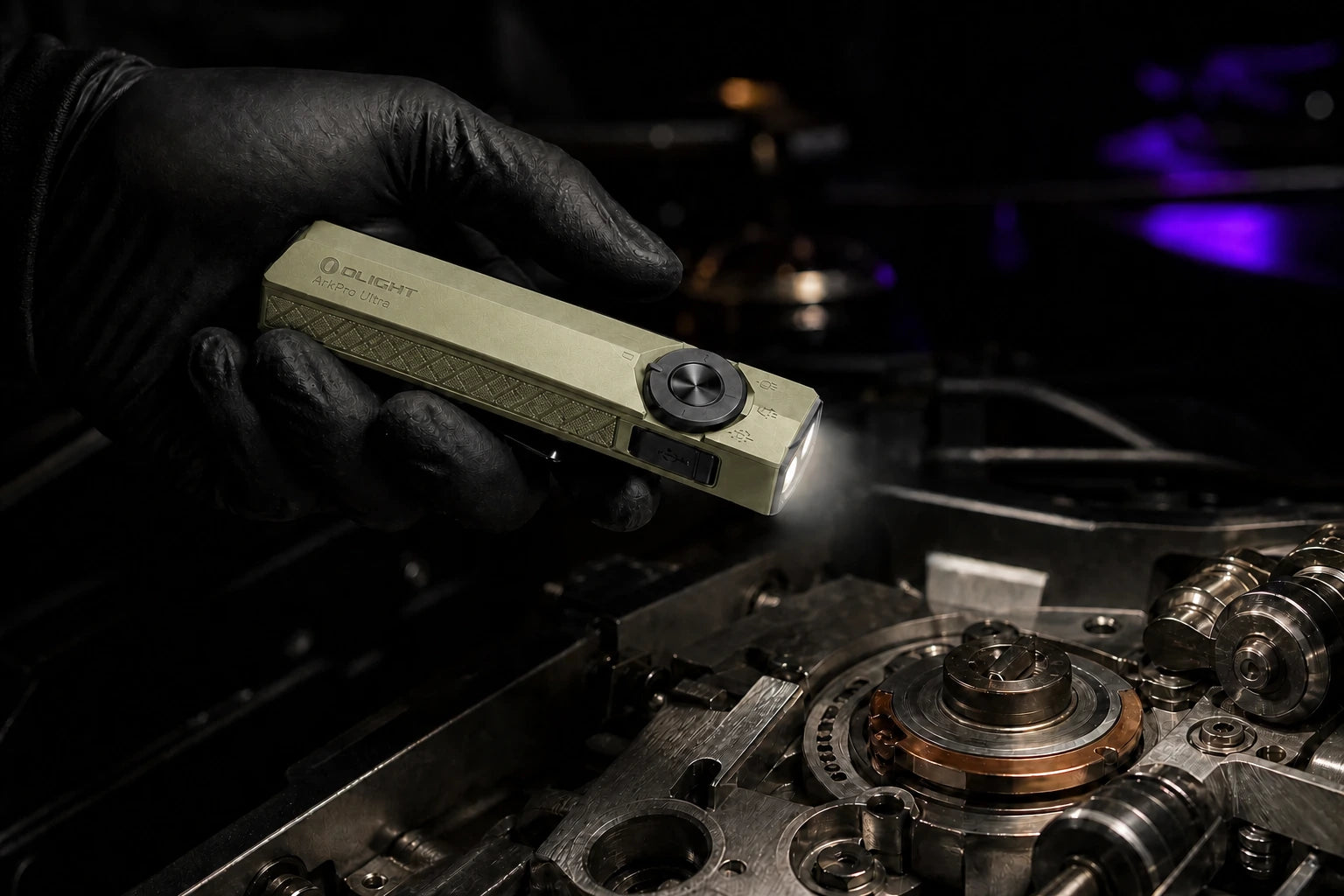 Olive Green ArkPro Ultra illuminating a precision repair with its broad floodlight