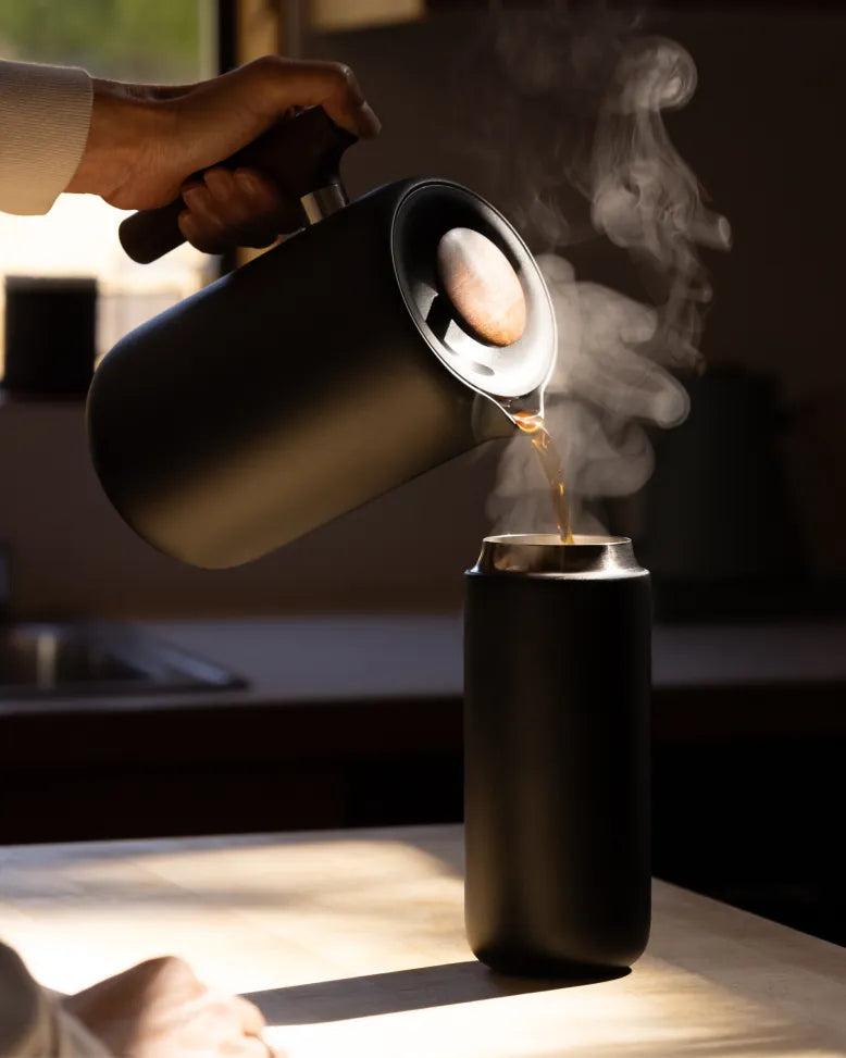 Coffee poured from the Clara French press into a Carter Move mug