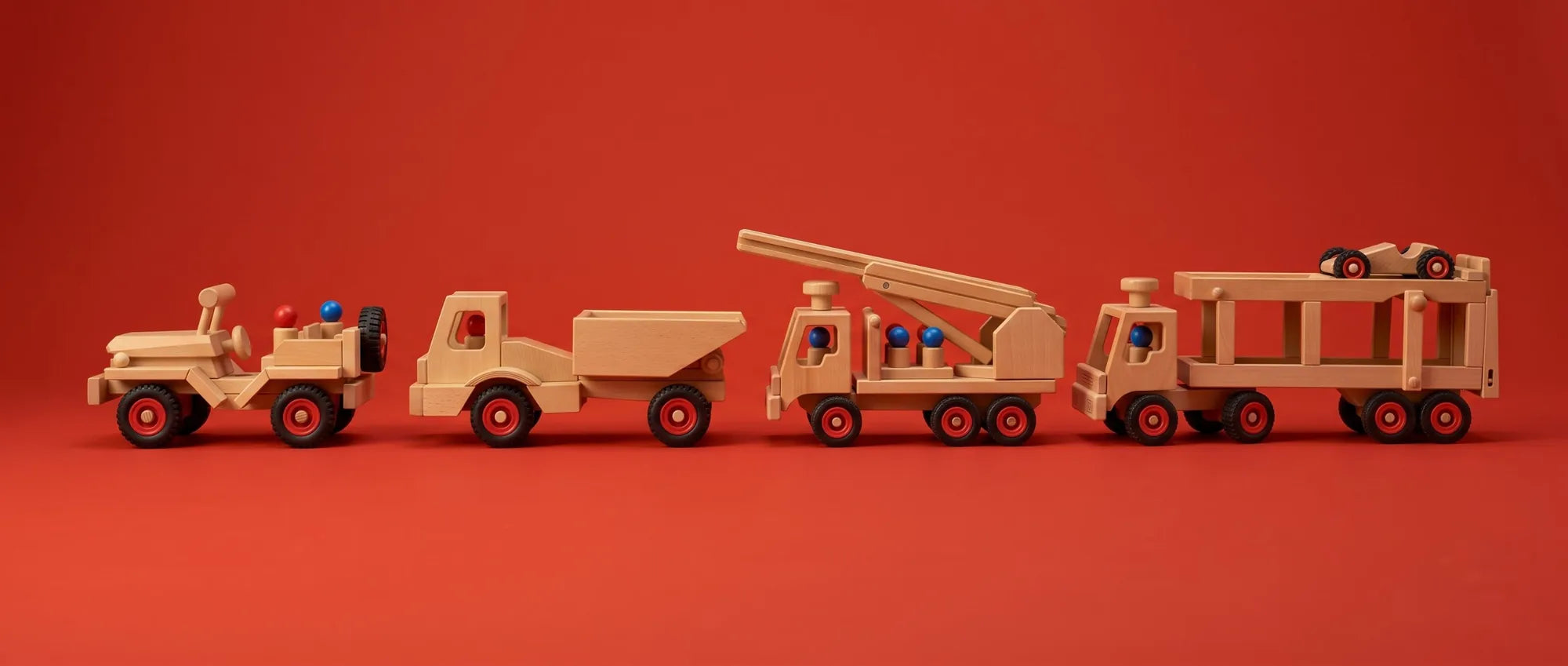 The Wooden Jeep, Wheels Dumper, Fire Engine and Car Transporter lined up nose to tail