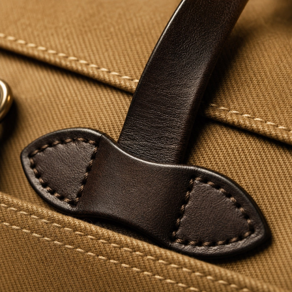 Macro of dark bridle-leather handle and saddle stitching