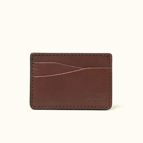 Close view of the cognac Journeyman cardholder showing leather grain, stitching, and curved card slots