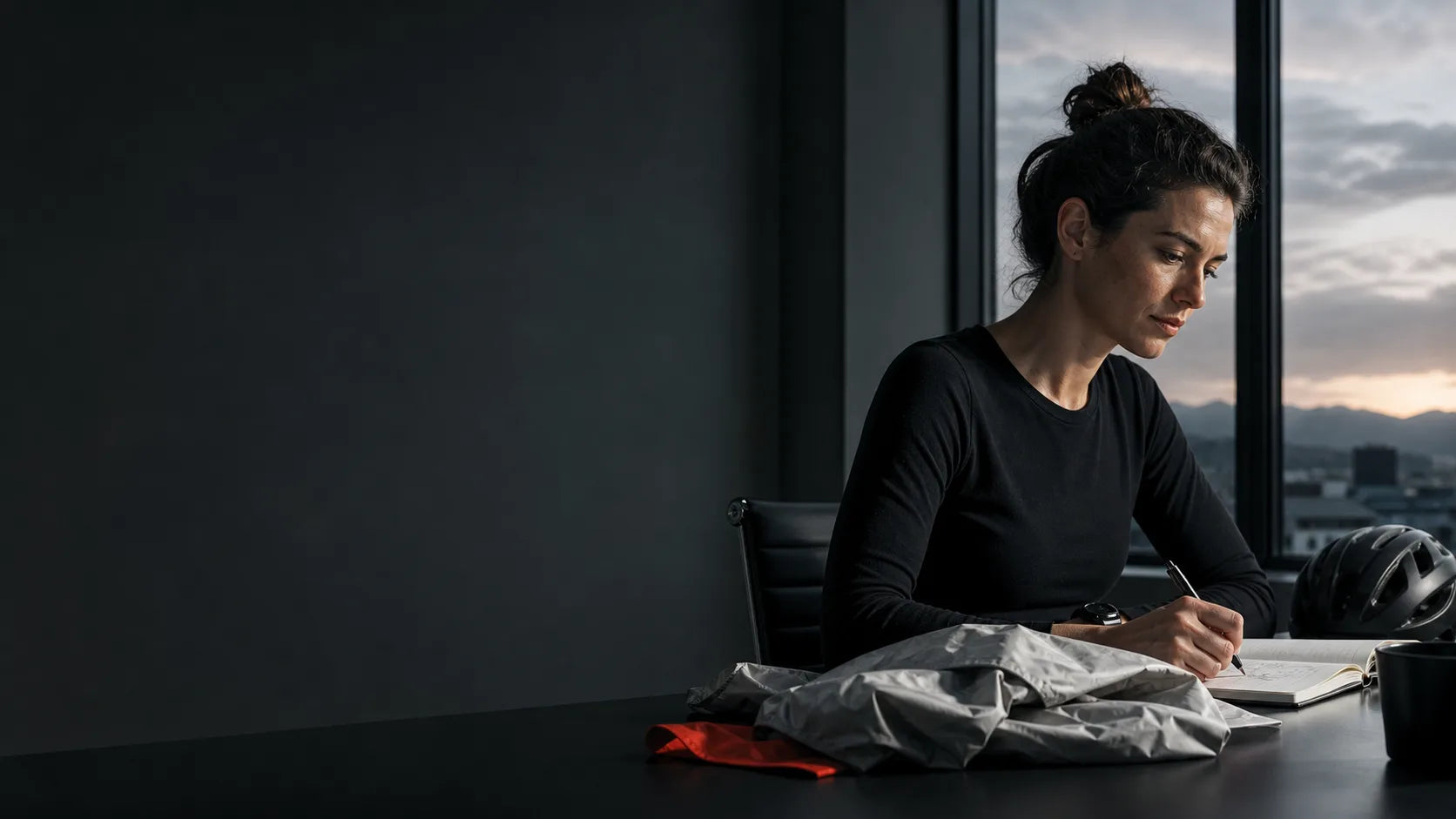A cyclist and creative professional working with calm focus before sunrise