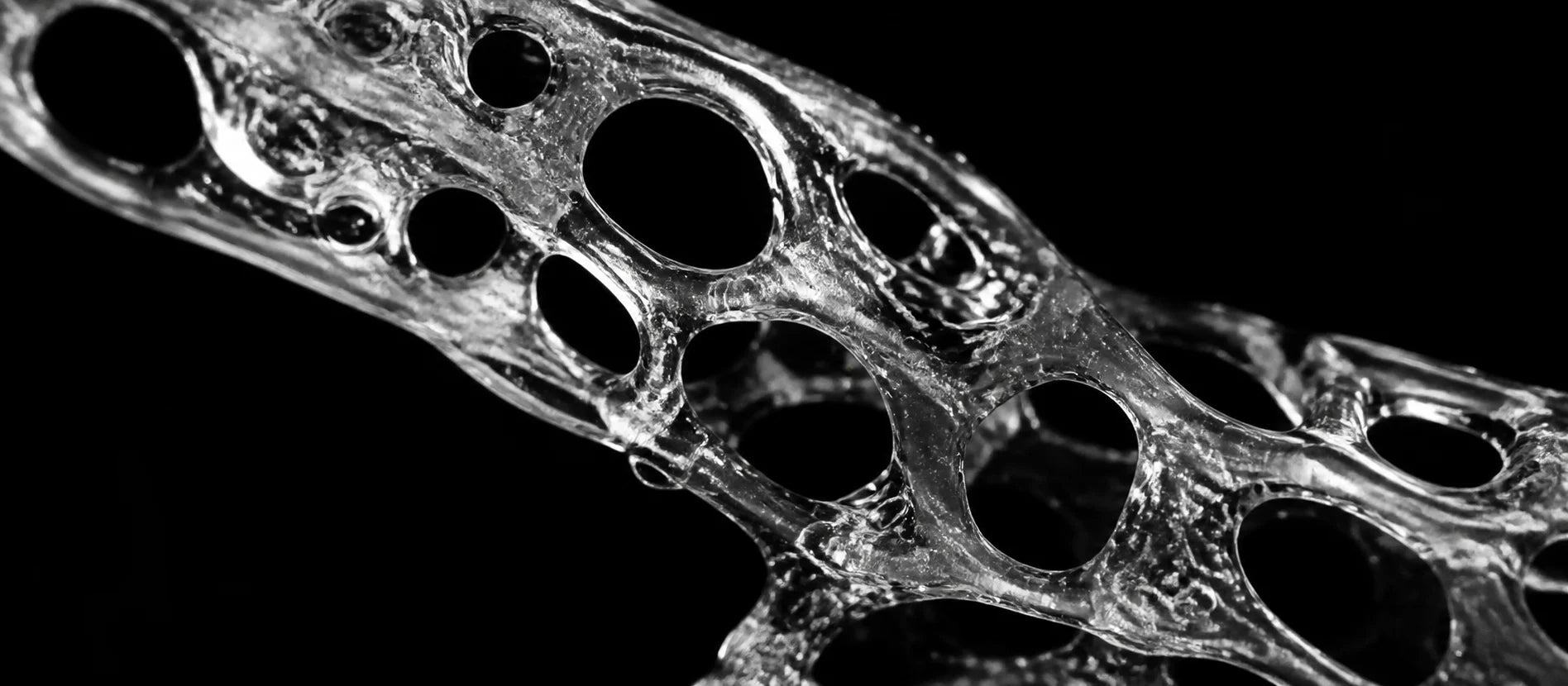 Conceptual monochrome macro study evoking a porous hydrogel structure