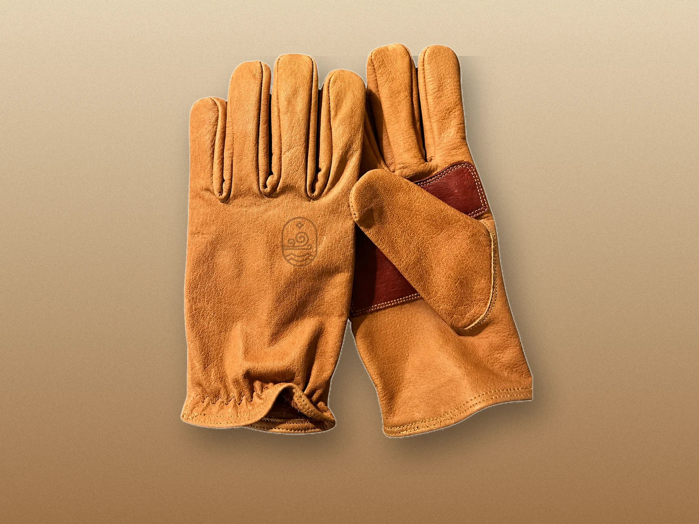 Actual clean saddle-tan buffalo leather gloves, back and reinforced palm shown