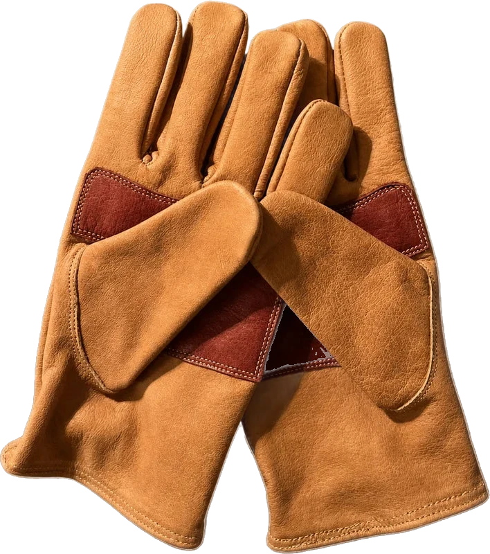 The gloves palm-up, oxblood palm heels crossed, lit warm from below
