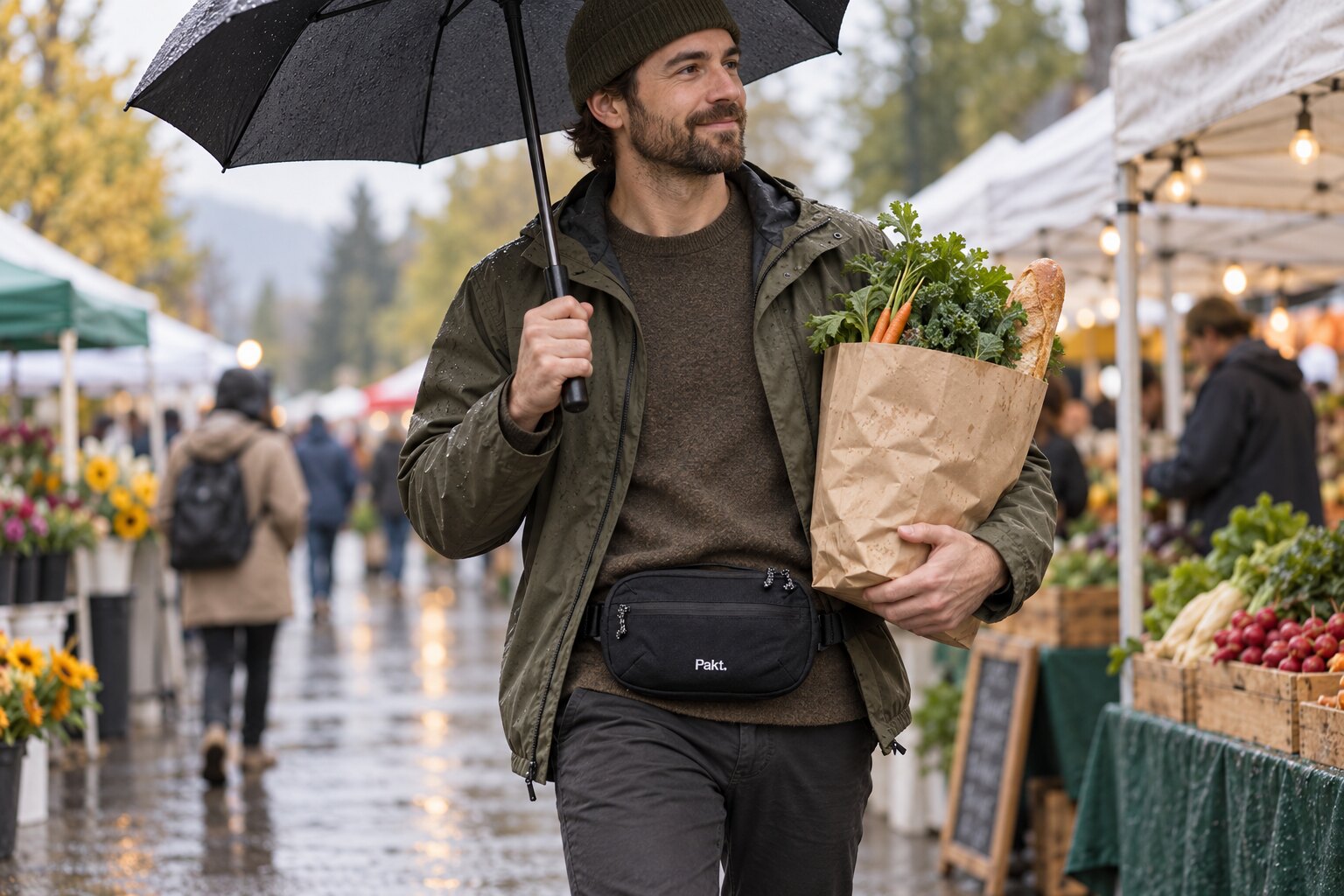 Black Pakt sling worn as a belt bag at a rainy market