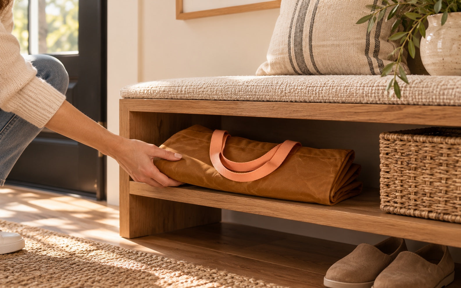 Whiskey and Peach Transport Tote folded flat on an entryway shelf