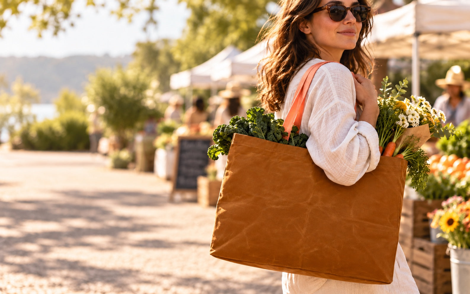 Woman carrying the large Whiskey and Peach Transport Tote at a farmers market