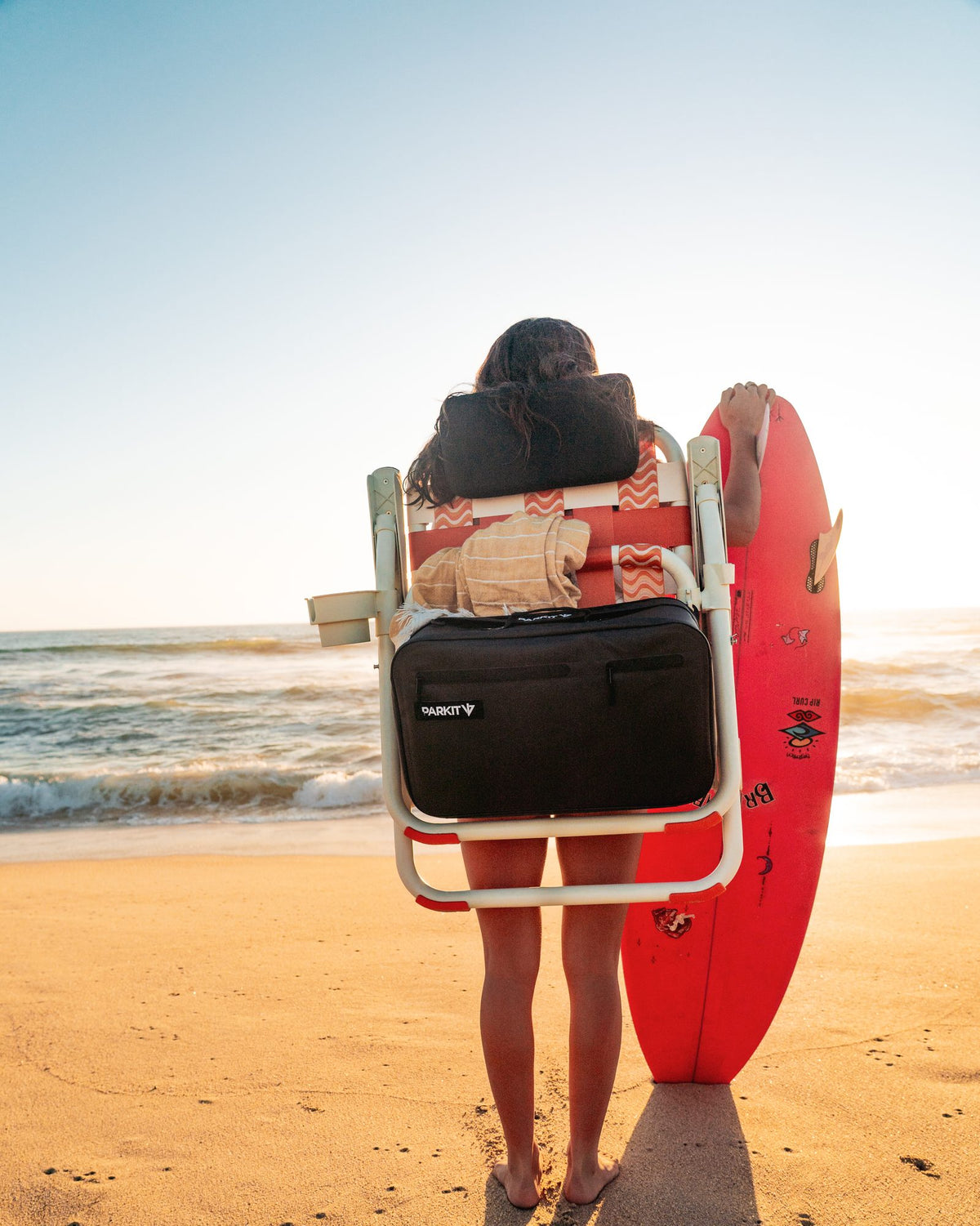 Person wearing the Sunkissed PARKIT Voyager as a backpack on the beach