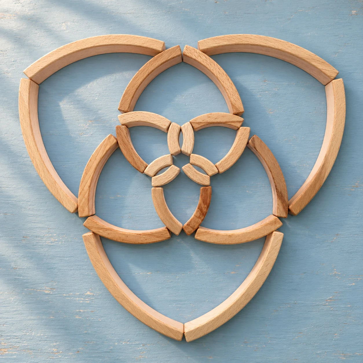 Golden Ratio Mini blocks in four graduated sizes on a sky-blue surface